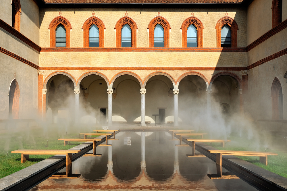 Middle Ages courtyard with pool in surreal fog