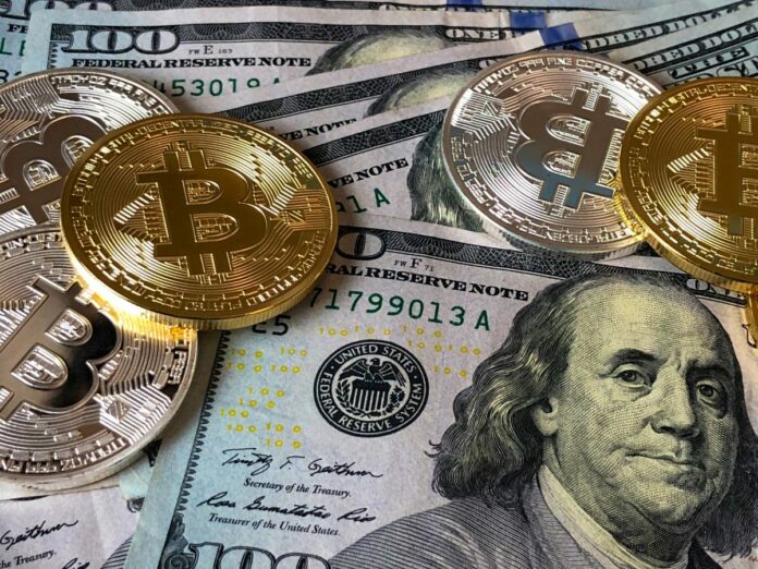 bitcoins-and-u-s-dollar-bills-730547