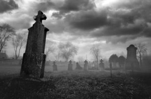 Old creepy graveyard on stormy winter day in black and white promise
