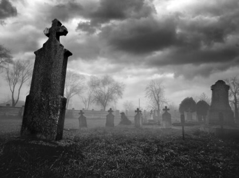 Old creepy graveyard on stormy winter day in black and white promise