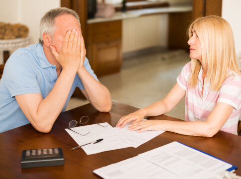 Worried couple calculating their expenses