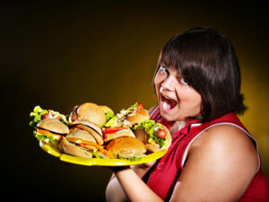 Woman holding hamburger.